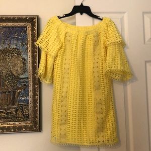Yellow patterned material dress.